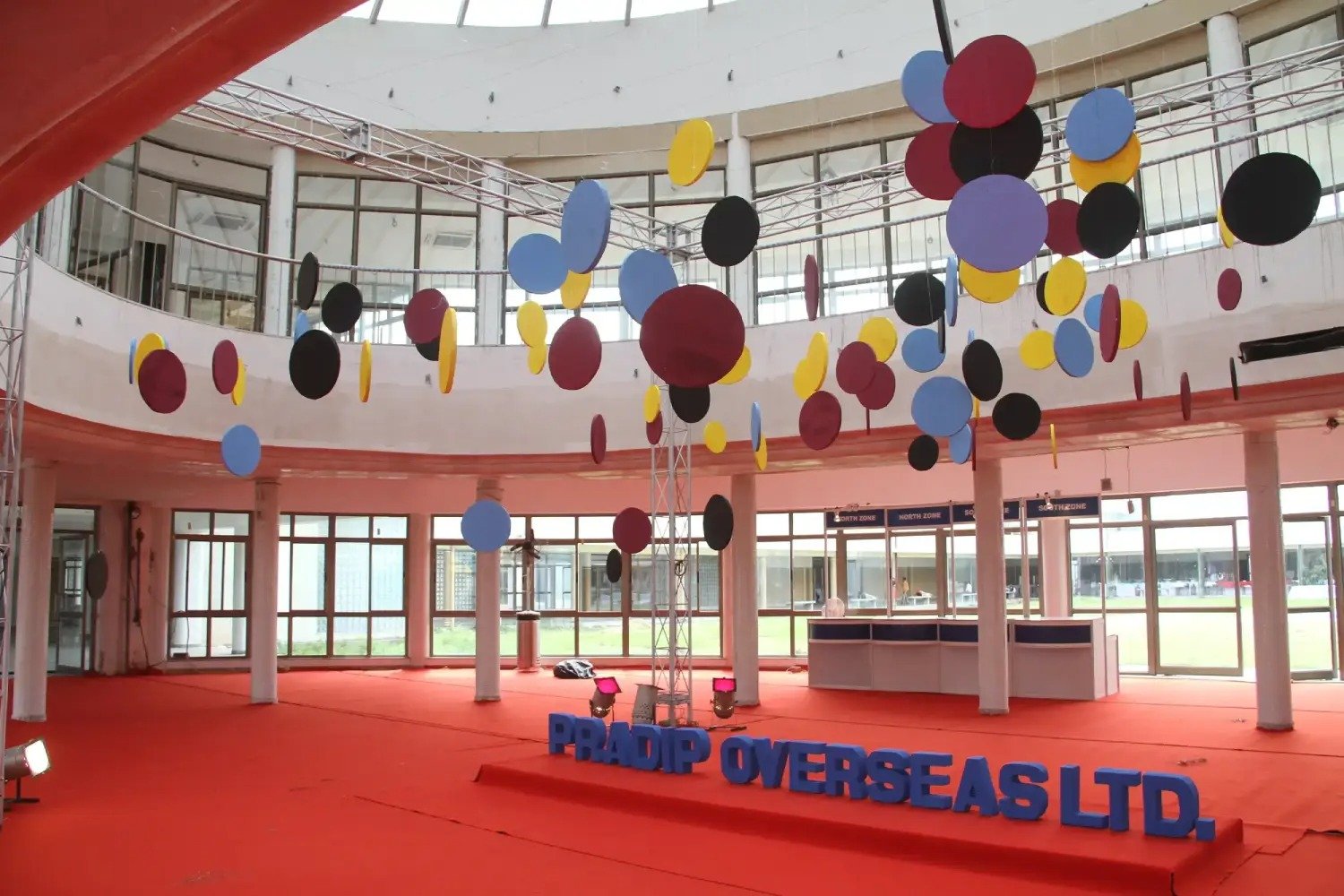 Man and woman speaking on stage at night with blue lighting